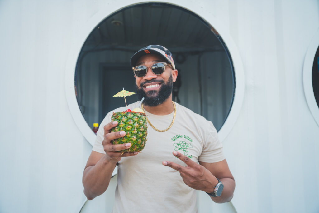 Man smiling holding pineapple